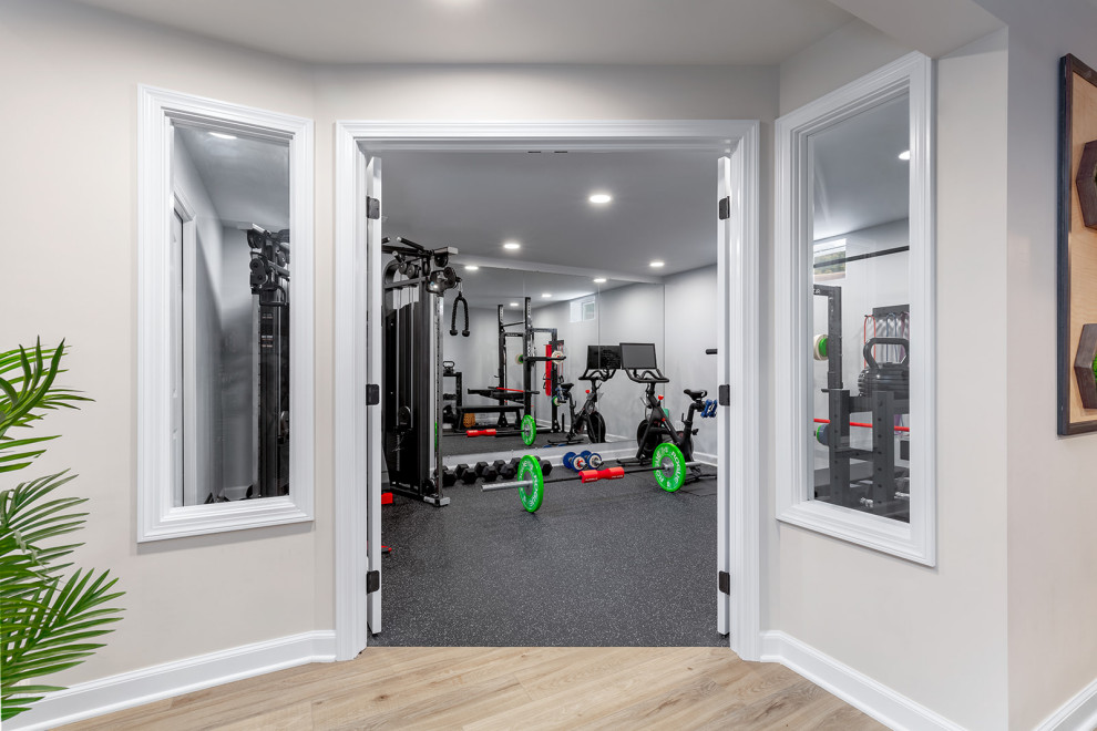 Photo of a large transitional multipurpose gym in Columbus with white walls and black floor.