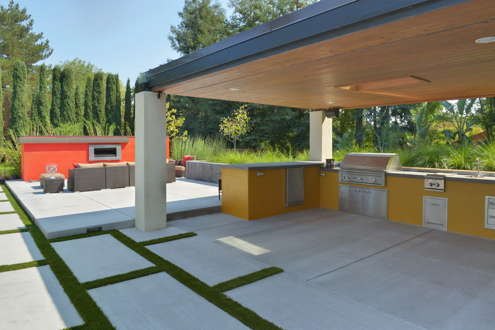 This is an example of an expansive contemporary backyard patio in San Francisco with concrete pavers.