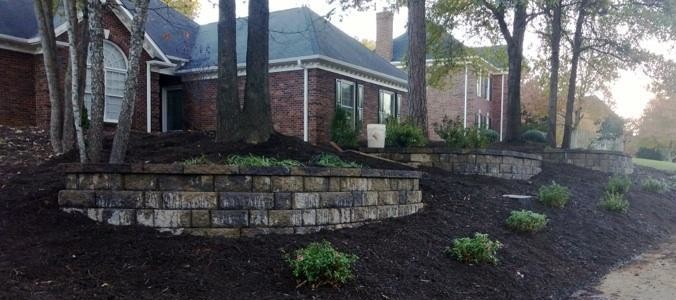 Design ideas for a mid-sized front yard garden in Charlotte with a retaining wall and natural stone pavers.