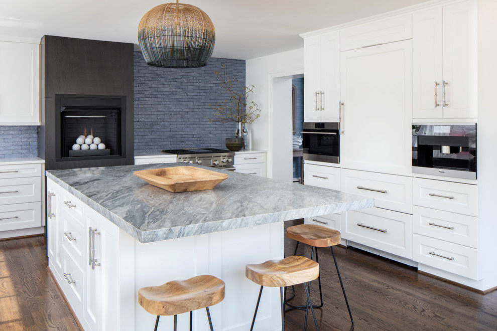 Transitional dark wood floor and brown floor enclosed kitchen photo in Richmond with shaker cabinets, white cabinets, gray backsplash, stainless steel appliances, an island and gray countertops