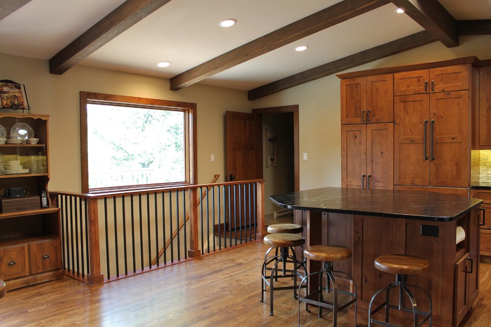 Large transitional l-shaped dark wood floor eat-in kitchen photo in Denver with a farmhouse sink, flat-panel cabinets, dark wood cabinets, granite countertops, beige backsplash, stainless steel appliances and an island
