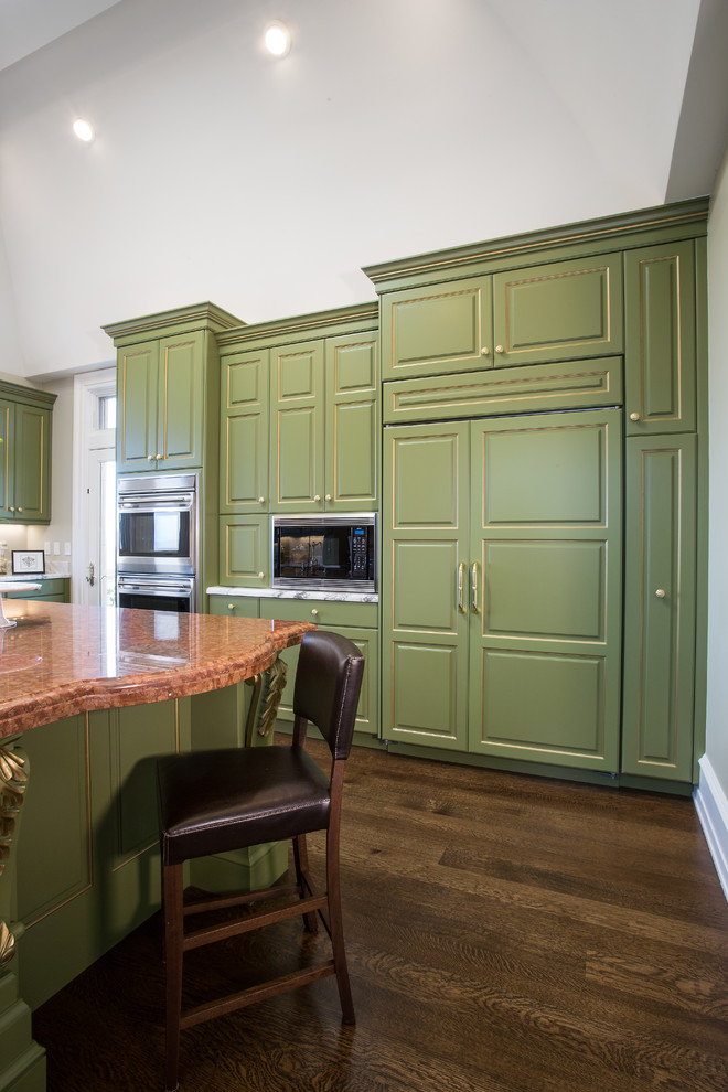 This is an example of an expansive traditional u-shaped eat-in kitchen in San Francisco with a drop-in sink, recessed-panel cabinets, green cabinets, granite benchtops, white splashback, stone slab splashback, stainless steel appliances, dark hardwood floors and multiple islands.