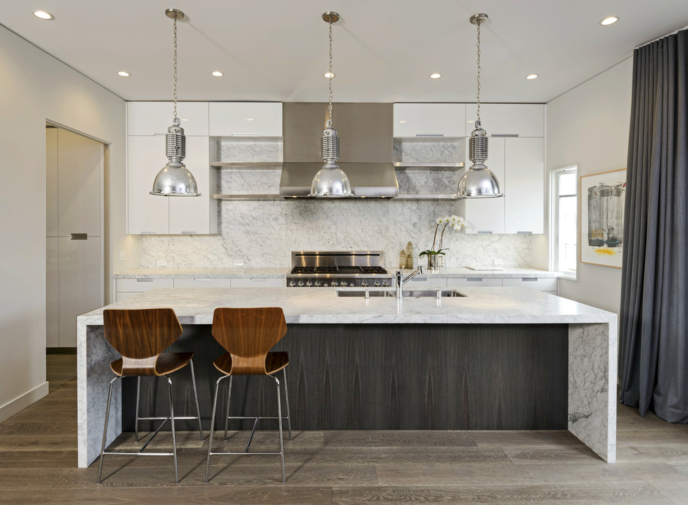 Inspiration for a large contemporary galley kitchen in San Francisco with an undermount sink, flat-panel cabinets, white cabinets, marble benchtops, stainless steel appliances, with island and multi-coloured splashback.