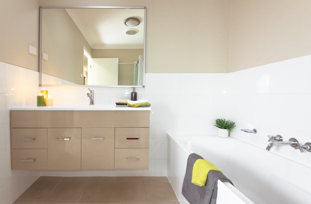 Design ideas for a small contemporary bathroom in Newcastle - Maitland with beige cabinets, a corner tub, white tile, beige walls and ceramic floors.
