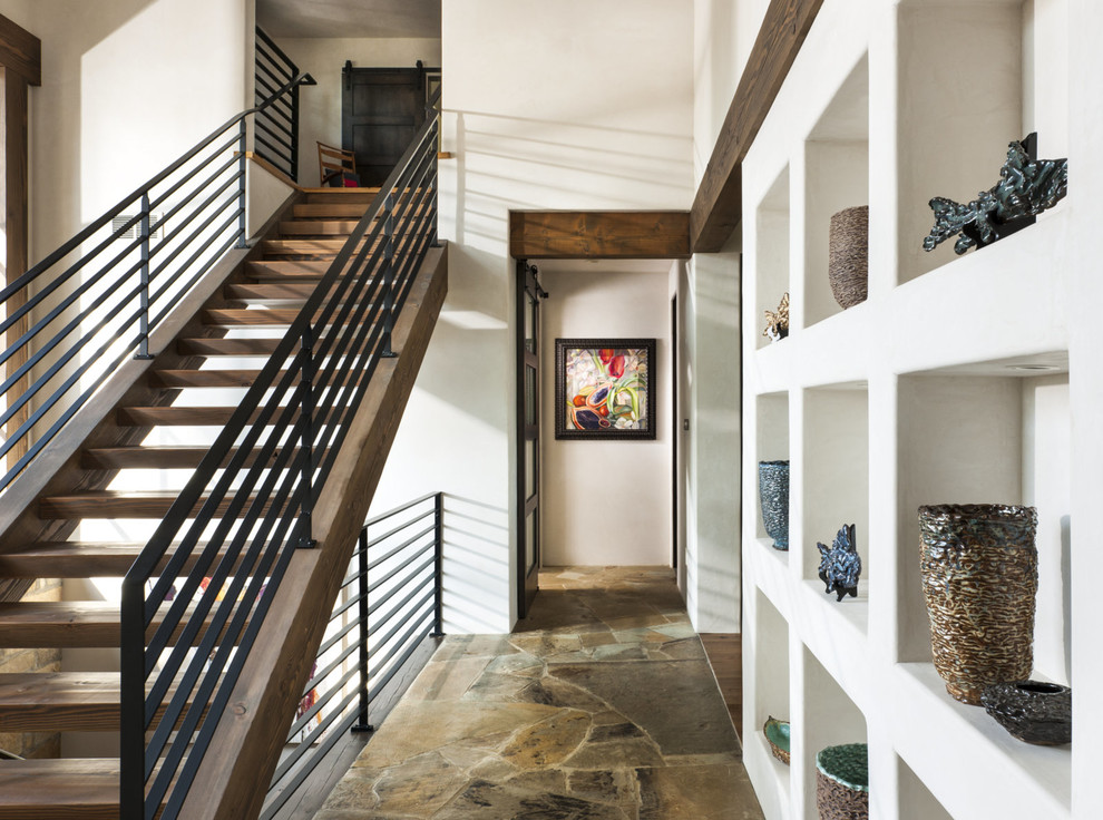 This is an example of a country entry hall in Other with white walls.