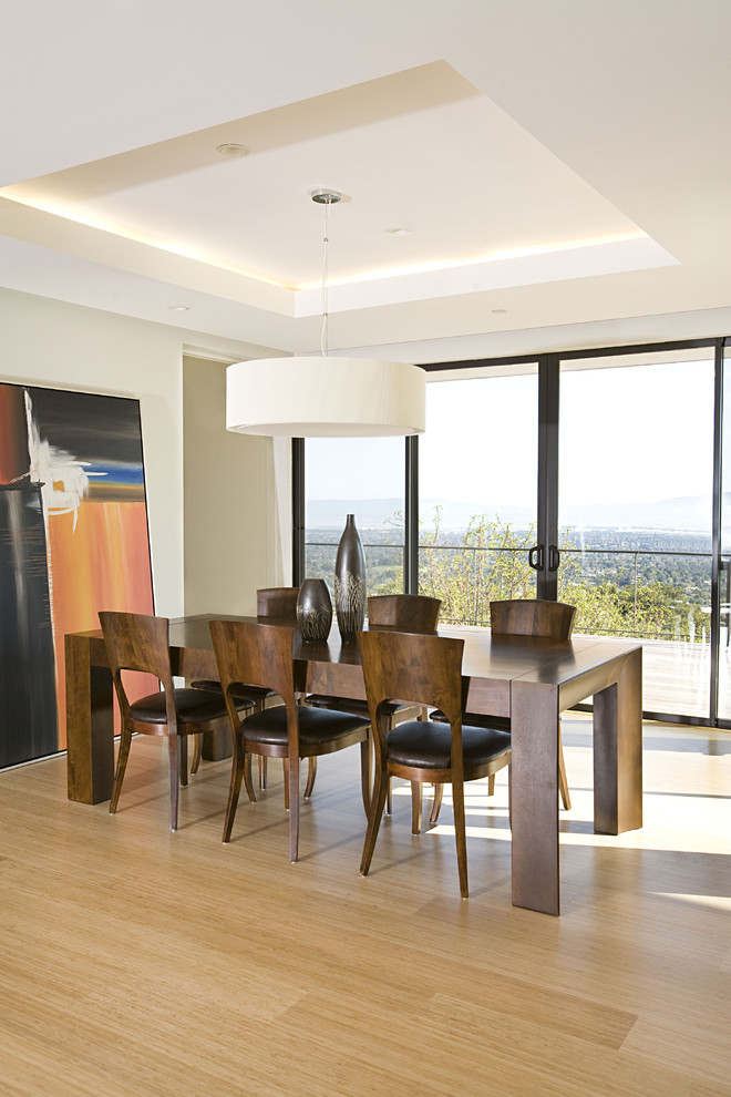 Contemporary dining room in San Francisco with bamboo floors and beige floor.