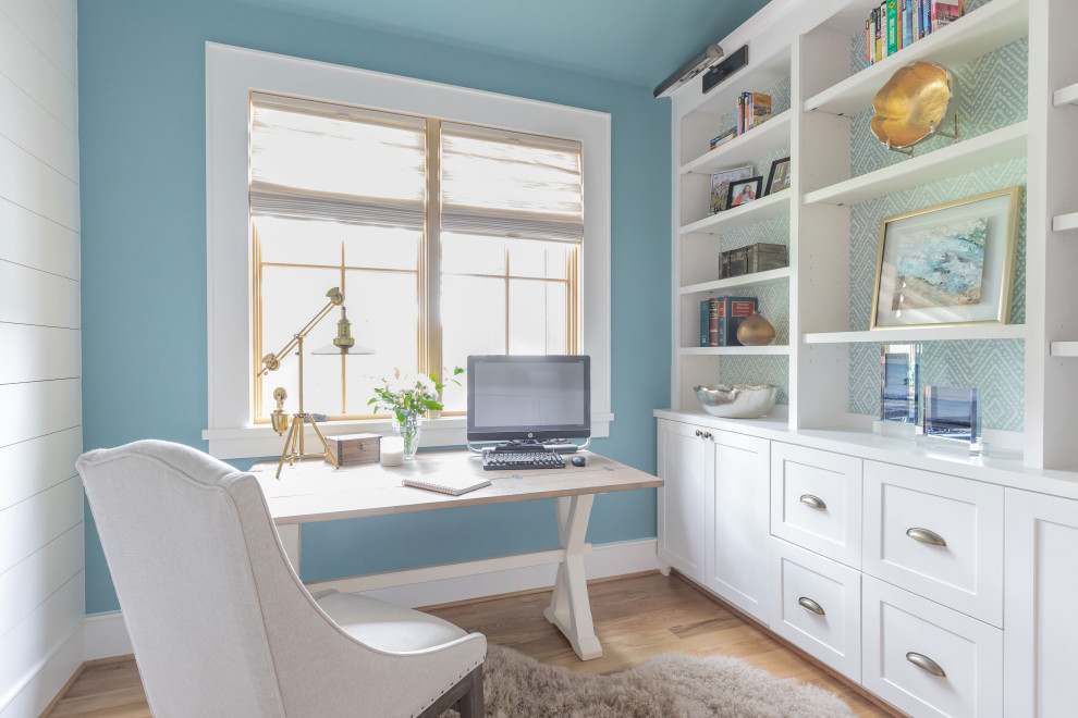Inspiration for a large country home office in Houston with blue walls, light hardwood floors, no fireplace, a freestanding desk and beige floor.