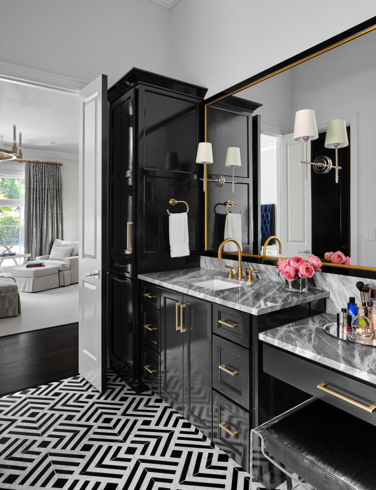 This is an example of a large transitional master bathroom with recessed-panel cabinets, black cabinets, an undermount tub, white walls, porcelain floors, an undermount sink, marble benchtops, a double vanity and a built-in vanity.