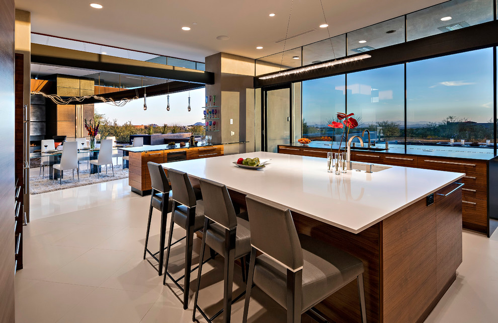 Large modern u-shaped eat-in kitchen in Phoenix with a double-bowl sink, flat-panel cabinets, dark wood cabinets, soapstone benchtops, beige splashback, stone slab splashback, stainless steel appliances, ceramic floors and with island.