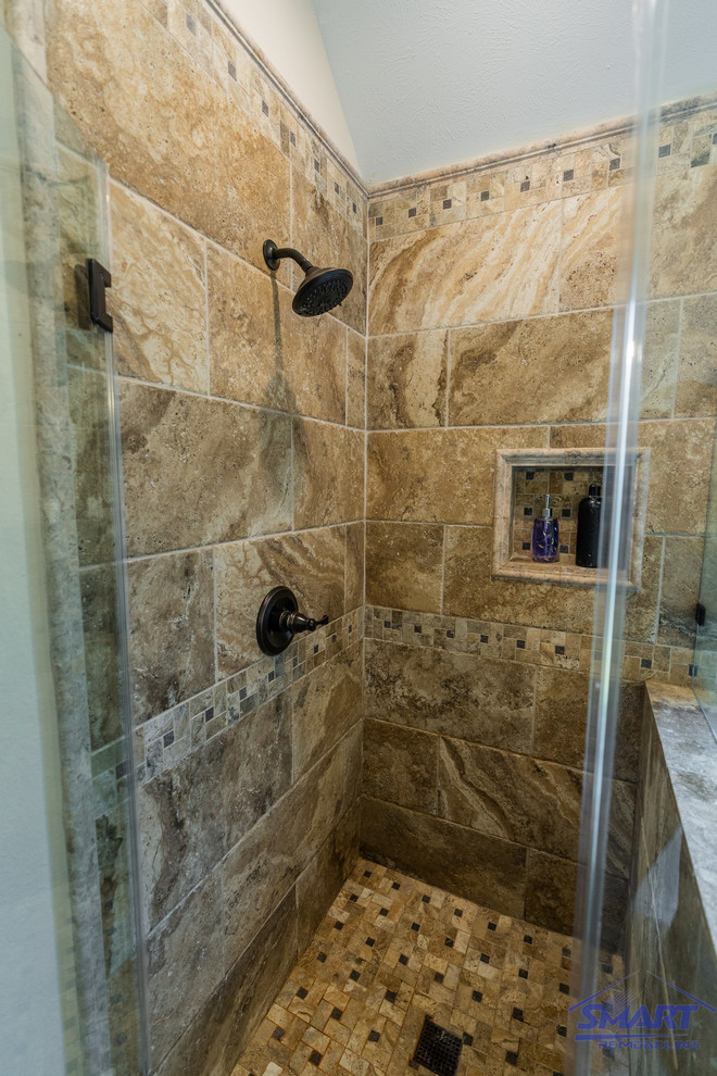 This is an example of a mid-sized transitional master bathroom in Houston with dark wood cabinets, a drop-in tub, granite benchtops, a hinged shower door, multi-coloured benchtops, raised-panel cabinets, a corner shower, a one-piece toilet, beige tile, white walls, porcelain floors, an undermount sink, beige floor, a double vanity, a built-in vanity, coffered, decorative wall panelling and porcelain tile.