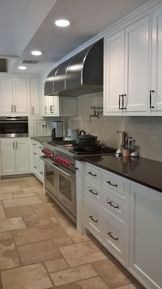 Transitional kitchen photo in Minneapolis with recessed-panel cabinets, white cabinets, granite countertops and beige backsplash
