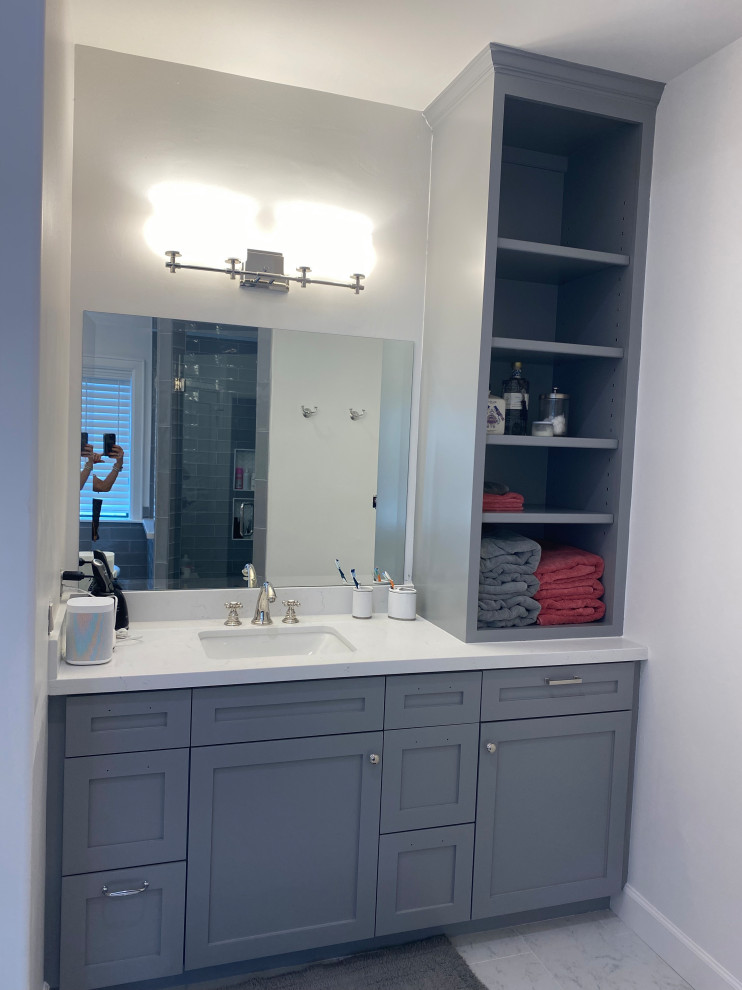 Photo of a contemporary master bathroom in Houston with shaker cabinets, a freestanding tub, a double shower, white walls, porcelain floors, an undermount sink, engineered quartz benchtops, white floor, a hinged shower door, a double vanity, a built-in vanity and blue cabinets.