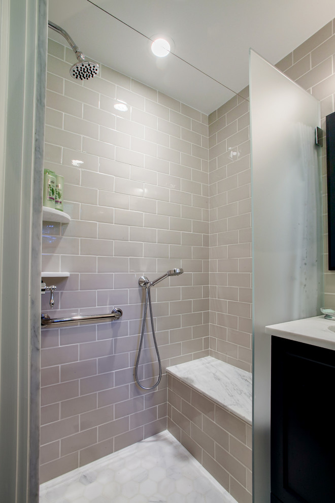 Inspiration for a small traditional 3/4 bathroom in New York with recessed-panel cabinets, marble benchtops, a curbless shower, ceramic tile, mosaic tile floors, a two-piece toilet and gray tile.
