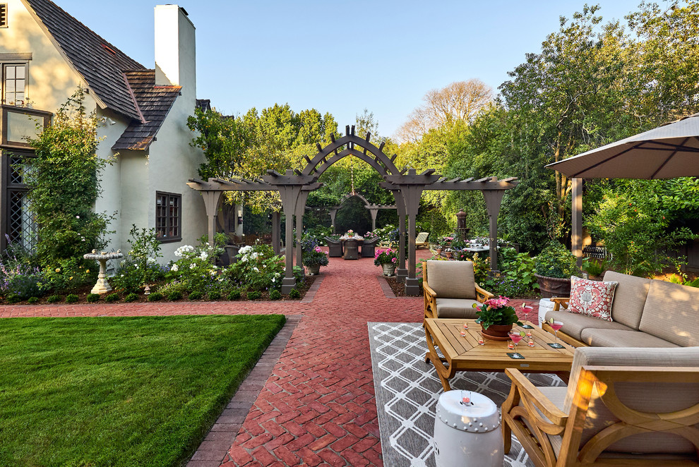 Inspiration for an expansive traditional backyard patio in San Francisco with a fire feature, brick pavers and no cover.