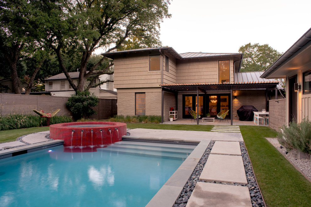Photo of a mid-sized contemporary backyard rectangular lap pool in Dallas with a hot tub and concrete slab.