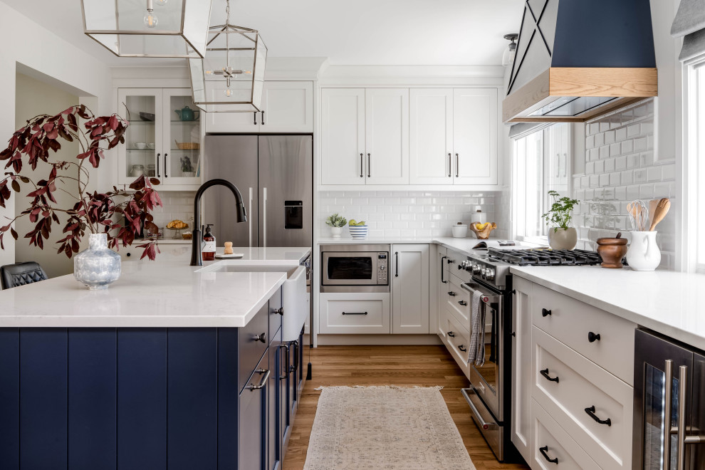 Inspiration for a large transitional l-shaped kitchen remodel in Toronto with shaker cabinets and an island