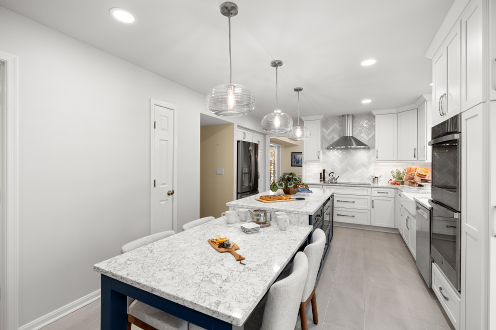 Mid-sized transitional kitchen photo in DC Metro with shaker cabinets, white cabinets, quartz countertops, porcelain backsplash, stainless steel appliances and an island