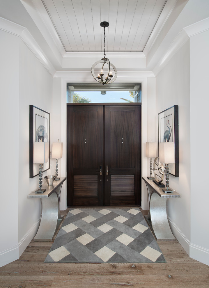 Example of a mid-sized transitional light wood floor foyer design in Miami with gray walls and a dark wood front door