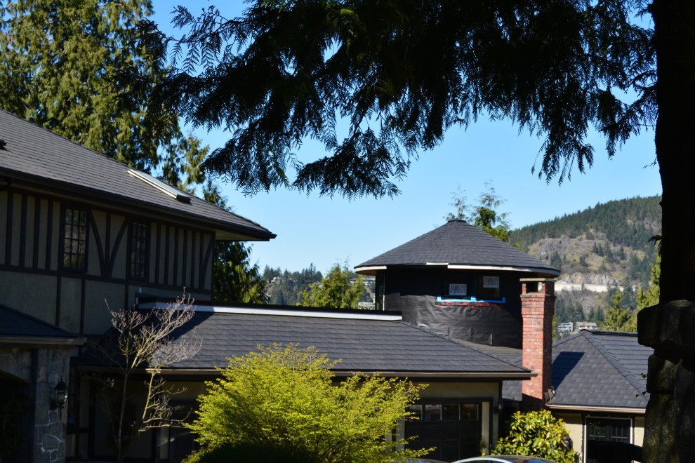 Inspiration for a large traditional white house exterior in Vancouver with four or more storeys, a gable roof, a shingle roof and a black roof.