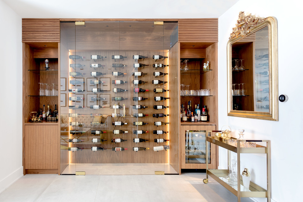 Contemporary wine cellar in Toronto with display racks and beige floor.