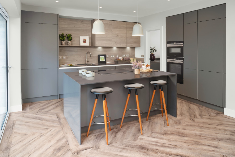 Design ideas for a contemporary l-shaped kitchen in Glasgow with flat-panel cabinets, grey cabinets, with island, beige floor and grey benchtop.