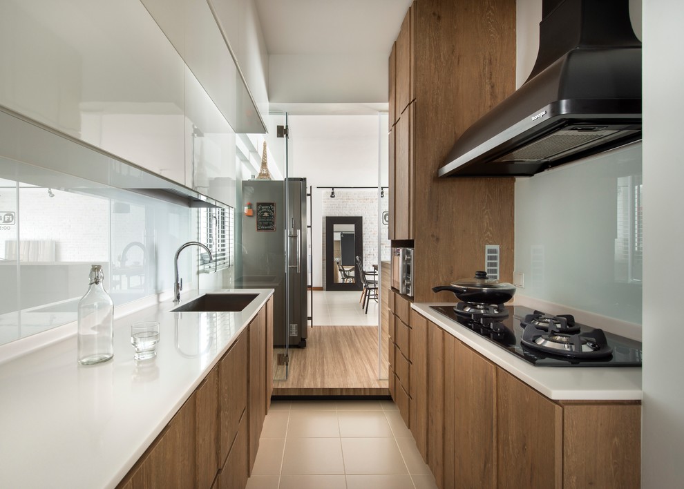 Contemporary galley kitchen in Singapore with an undermount sink, flat-panel cabinets, medium wood cabinets, white splashback, glass sheet splashback and no island.