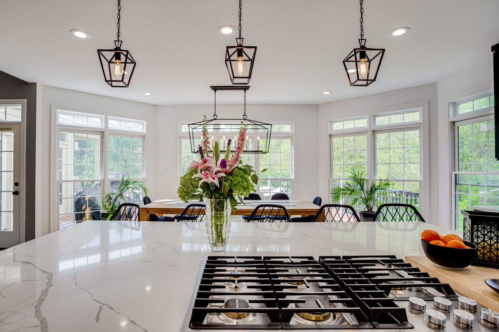 Inspiration for a large transitional u-shaped eat-in kitchen remodel in DC Metro with a farmhouse sink, quartz countertops, stainless steel appliances and an island