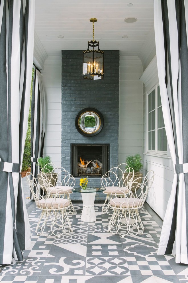 This is an example of a traditional patio in New York with a roof extension and with fireplace.