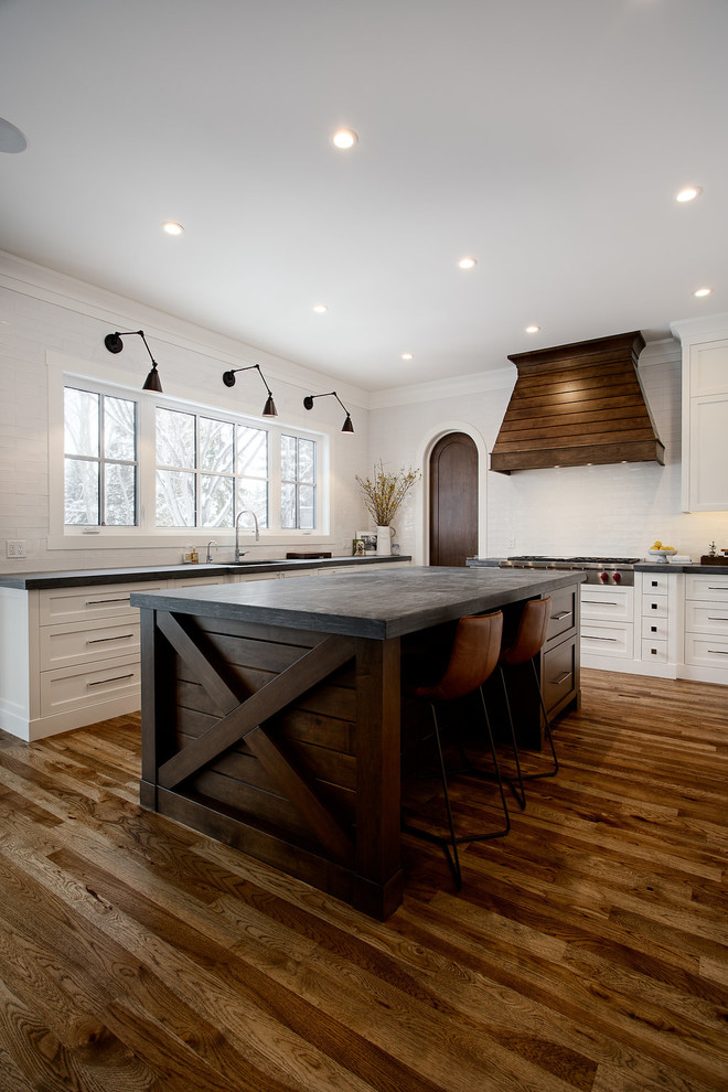 Large transitional u-shaped eat-in kitchen photo in Calgary with shaker cabinets, paneled appliances and an island