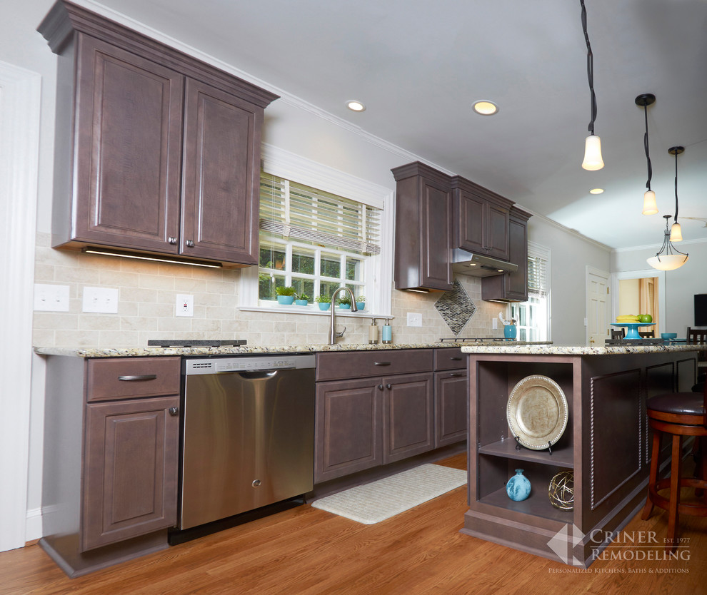 Inspiration for a transitional light wood floor eat-in kitchen remodel with shaker cabinets, dark wood cabinets, granite countertops, beige backsplash, glass tile backsplash, stainless steel appliances and an island