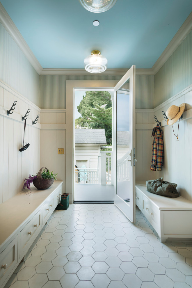 Photo of a beach style entryway in Other with green walls, a single front door, a glass front door, white floor, planked wall panelling, decorative wall panelling and wallpaper.