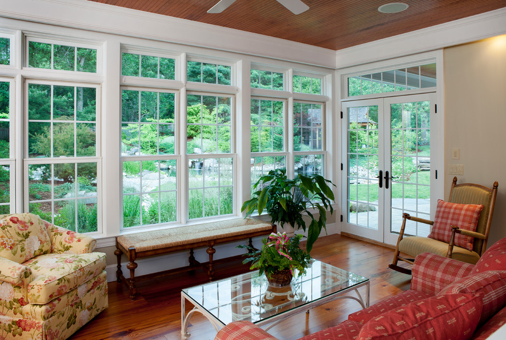 Large traditional sunroom in Boston with medium hardwood floors, no fireplace and a standard ceiling.