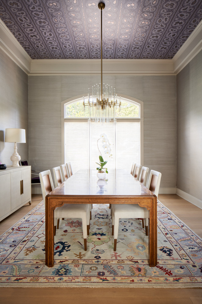 Large transitional medium tone wood floor, wallpaper ceiling and wallpaper dining room photo in Austin