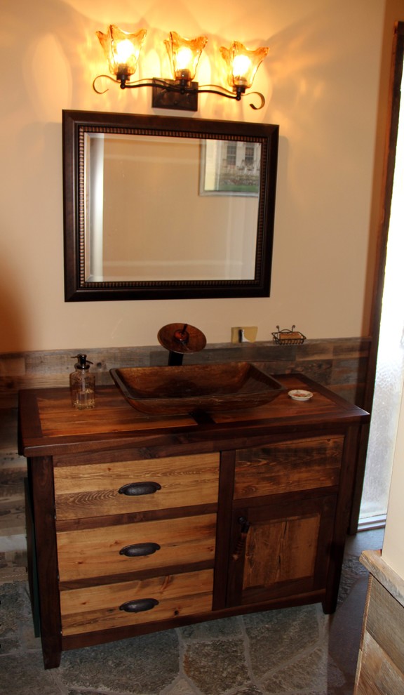 Photo of a mid-sized country bathroom in DC Metro with recessed-panel cabinets, distressed cabinets, gray tile, stone tile, orange walls, slate floors and wood benchtops.