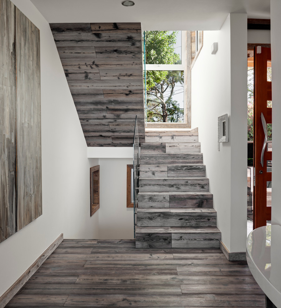 Inspiration for a mid-sized contemporary wood u-shaped staircase in Los Angeles with wood risers.
