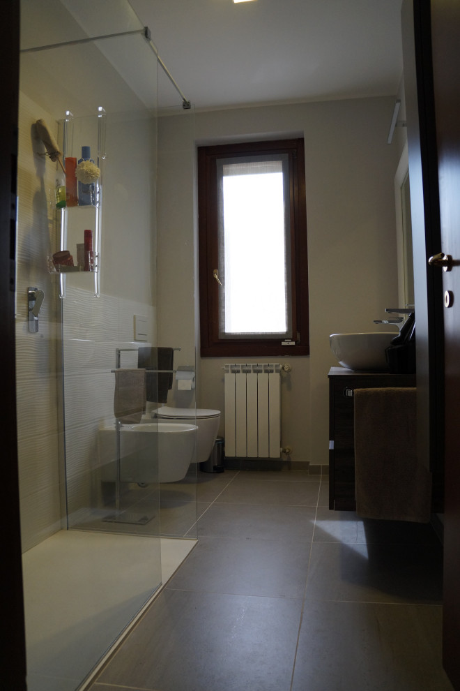 Photo of a medium sized contemporary cloakroom in Milan with flat-panel cabinets, dark wood cabinets, a wall mounted toilet, white tiles, porcelain tiles, white walls, brick flooring, a vessel sink, laminate worktops, red floors, brown worktops and a floating vanity unit.