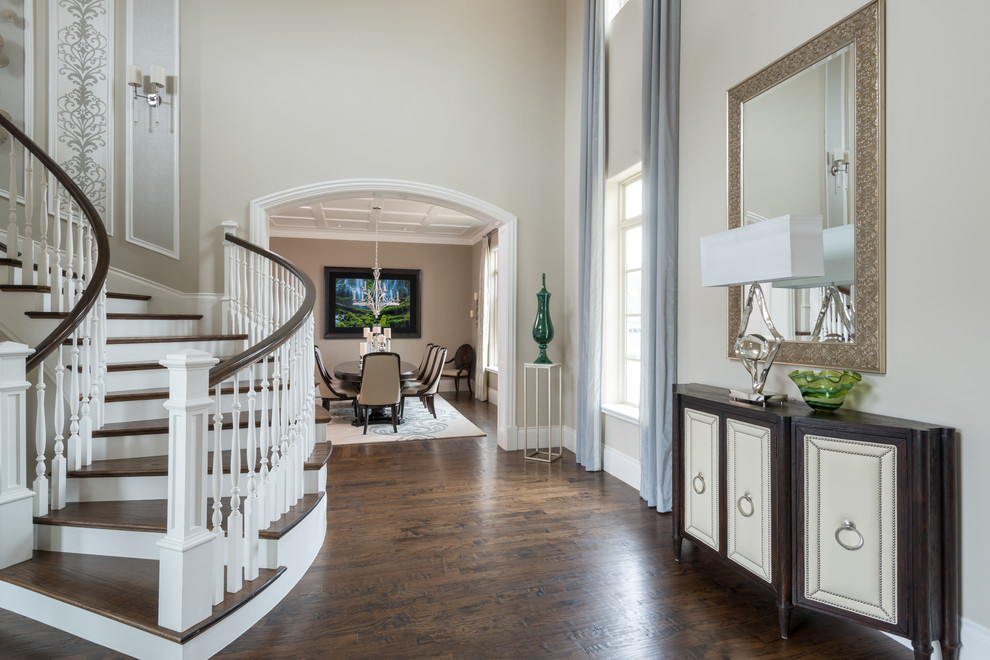 Photo of a mid-sized transitional foyer in Dallas with beige walls, dark hardwood floors and brown floor.