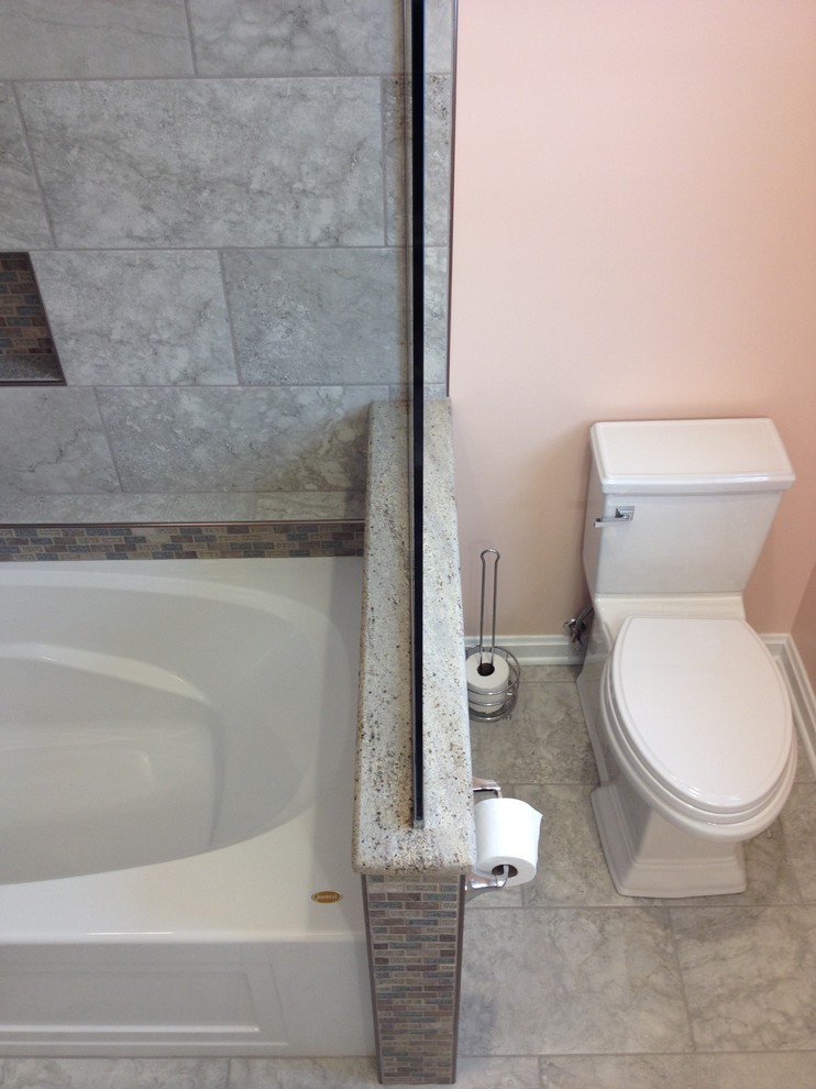 Inspiration for a mid-sized transitional kids' gray tile and porcelain tile porcelain tile alcove bathtub remodel with an undermount sink, raised-panel cabinets, white cabinets, granite countertops and orange walls