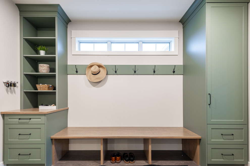 Mudroom - small transitional laminate floor, brown floor and wall paneling mudroom idea in Toronto with white walls and a white front door