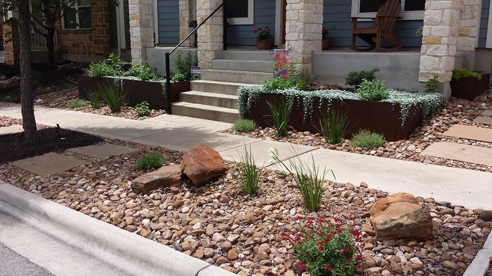 Photo of a mid-sized traditional full sun front yard stone landscaping in Austin.