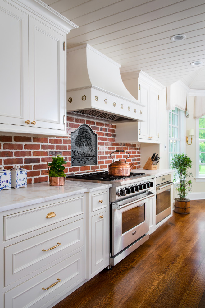 Large traditional eat-in kitchen in Philadelphia with a farmhouse sink, beaded inset cabinets, blue cabinets, quartzite benchtops, brick splashback, stainless steel appliances, dark hardwood floors, multiple islands, brown floor, multi-coloured benchtop and wood.