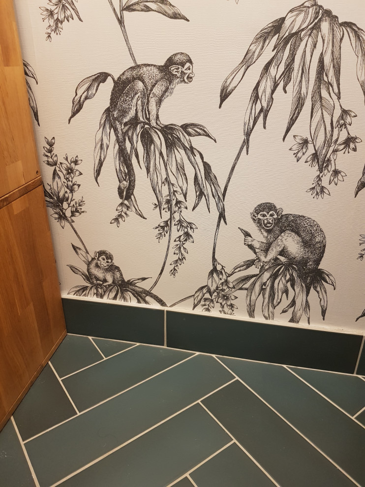 Cette image montre un WC suspendu ethnique avec un mur vert, un sol en carrelage de céramique, un lavabo suspendu, un sol vert et du papier peint.