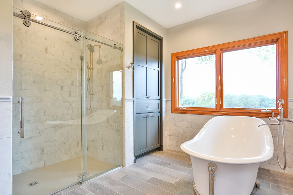 Large transitional master bathroom in Austin with shaker cabinets, grey cabinets, a claw-foot tub, an alcove shower, a one-piece toilet, gray tile, marble, an undermount sink, solid surface benchtops, a sliding shower screen and yellow benchtops.