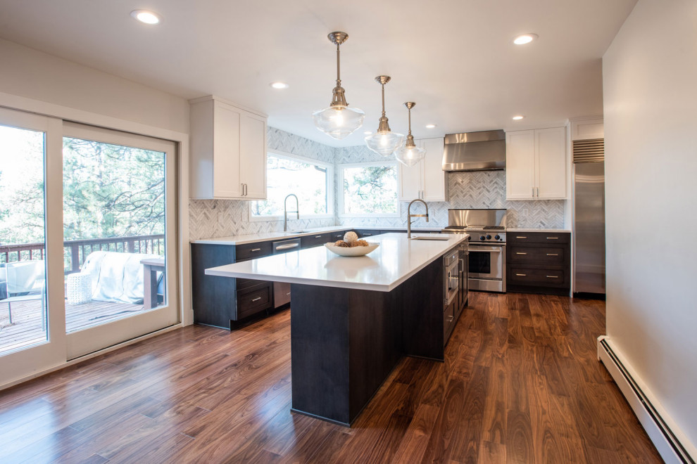 Inspiration for a mid-sized contemporary l-shaped eat-in kitchen in Santa Barbara with an undermount sink, shaker cabinets, white cabinets, stainless steel appliances, medium hardwood floors and with island.