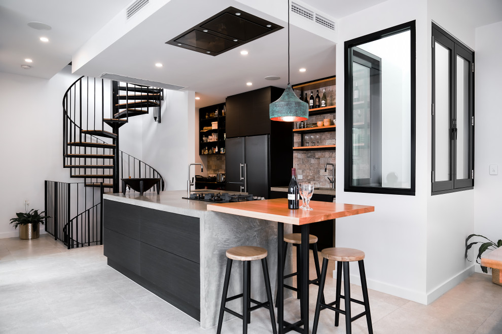 Inspiration for a contemporary single-wall eat-in kitchen in Adelaide with black cabinets, stainless steel appliances, ceramic floors, with island, grey floor, a single-bowl sink, flat-panel cabinets, multi-coloured splashback and grey benchtop.