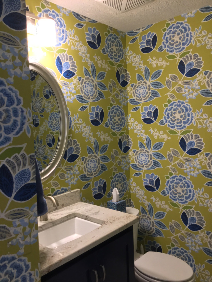 Design ideas for a small transitional powder room in Columbus with blue cabinets, a two-piece toilet, multi-coloured walls, an undermount sink, granite benchtops, shaker cabinets, vinyl floors and white floor.