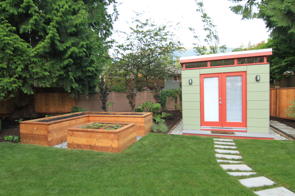 Inspiration for a large contemporary backyard partial sun garden in Vancouver with concrete pavers.