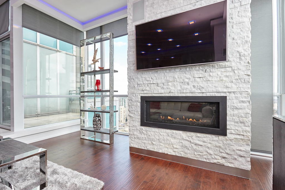 Mid-sized modern open concept living room in Toronto with white walls, dark hardwood floors, a ribbon fireplace, a stone fireplace surround and a wall-mounted tv.