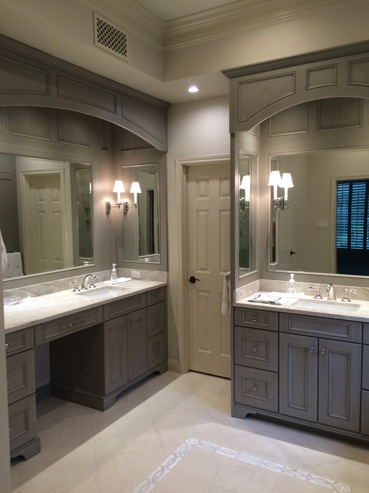 Inspiration for a large transitional master bathroom in Houston with an undermount sink, furniture-like cabinets, distressed cabinets, quartzite benchtops, an undermount tub, a corner shower, a one-piece toilet, beige tile, stone tile, beige walls and limestone floors.