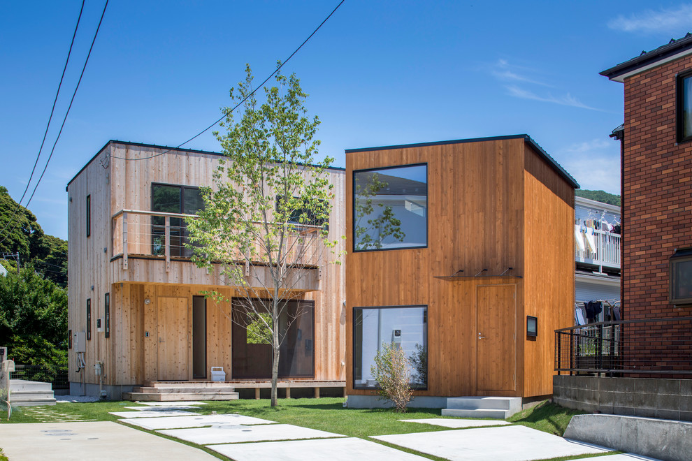 Photo of a contemporary brown exterior in Other with wood siding and a flat roof.
